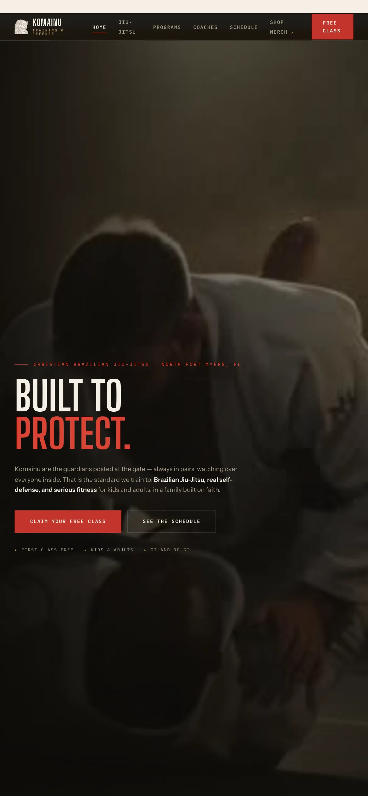 Komainu Training & Defense on a phone — “Built to protect” over a dimly lit grappling photo, with Claim your free class and See the schedule buttons and a “First class free” note beneath.
